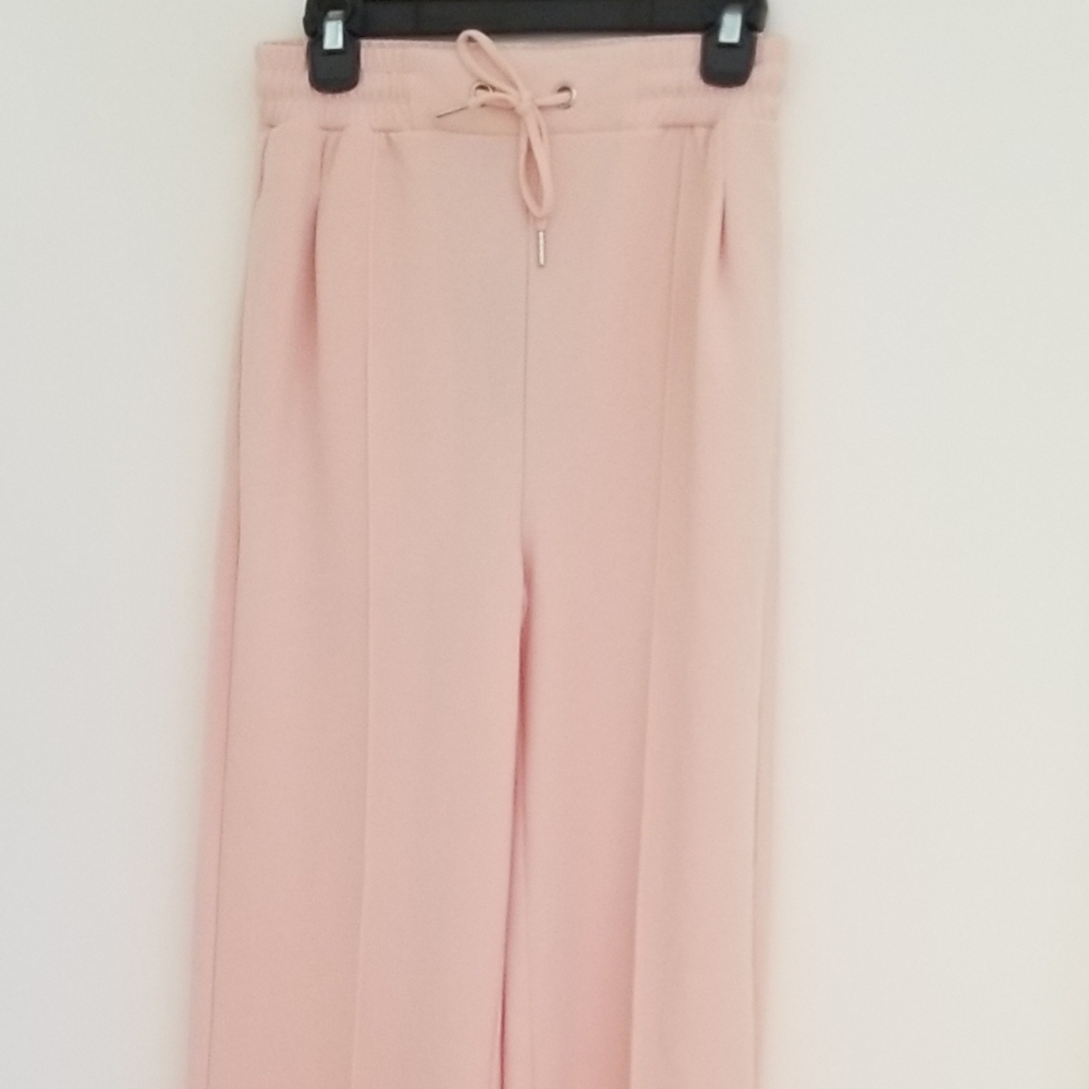 Light pink trousers with wide legs